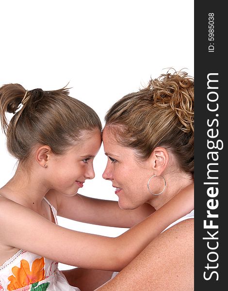 Mother and daughter embracing with foreheads touching. Mother and daughter embracing with foreheads touching