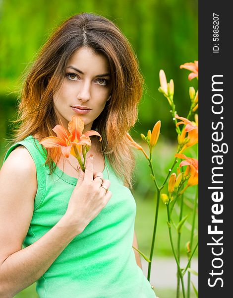 Beautiful woman in garden with flowers