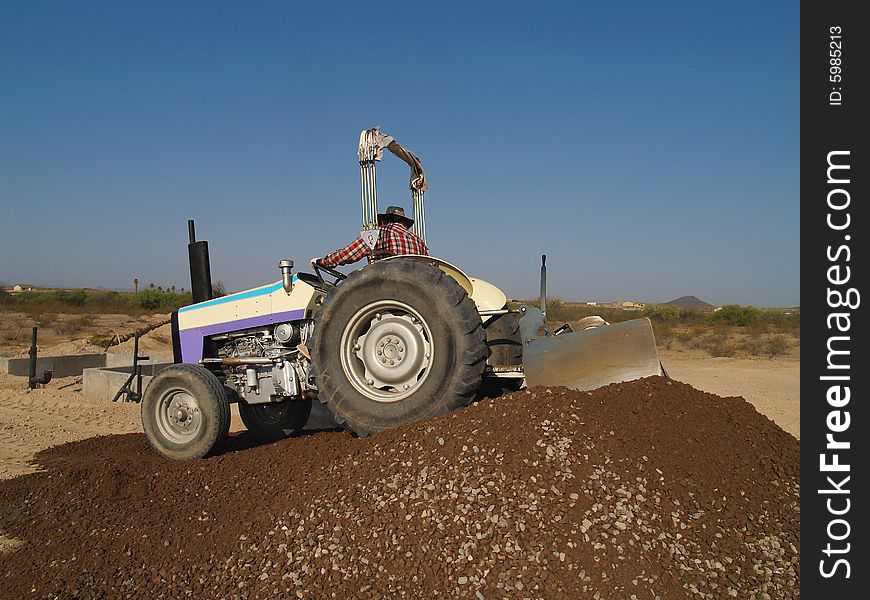 Man On Tractor Pushing Dirt - Horizontal