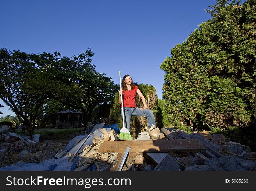 Woman Standing On PIle Of Rubble - Horizontal