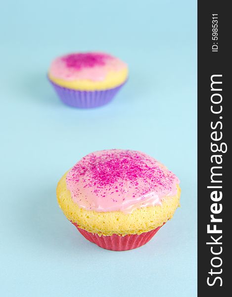 Cup cakes isolated against a blue background