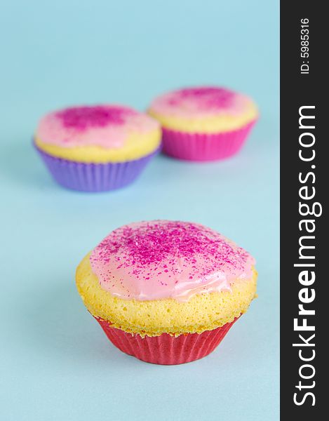 Cup cakes isolated against a blue background