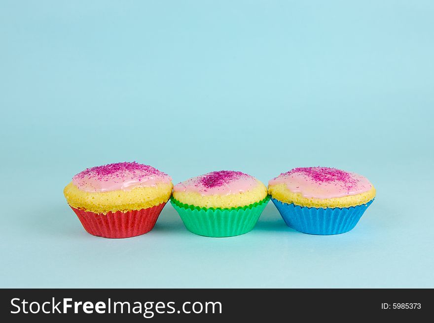 Cup cakes isolated against a blue background