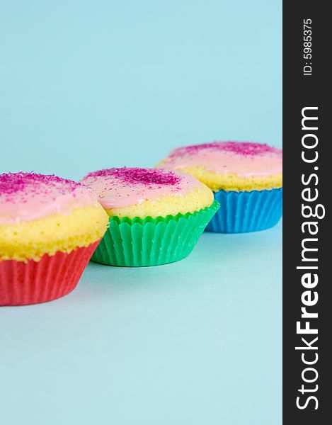 Cup cakes isolated against a blue background