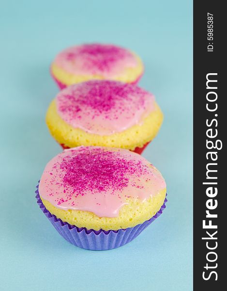 Cup cakes isolated against a blue background