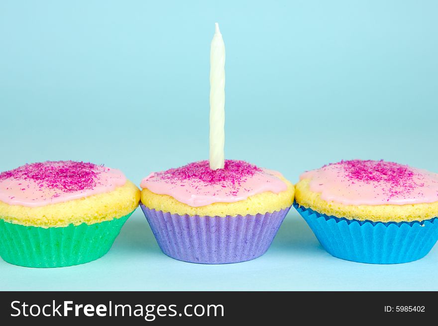 Cup cakes isolated against a blue background