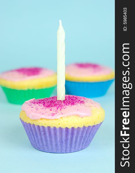 Cup cakes isolated against a blue background