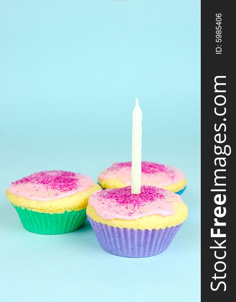 Cup cakes isolated against a blue background