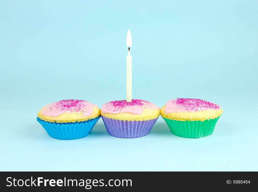 Cup cakes isolated against a blue background