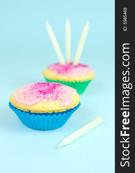 Cup cakes isolated against a blue background