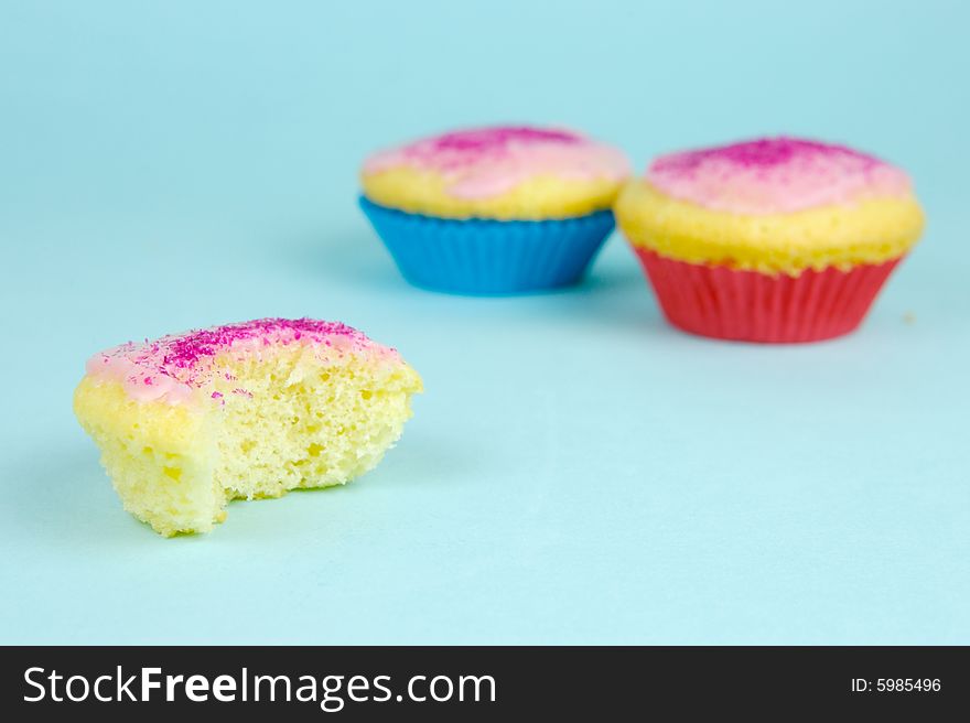 Cup cakes isolated against a blue background