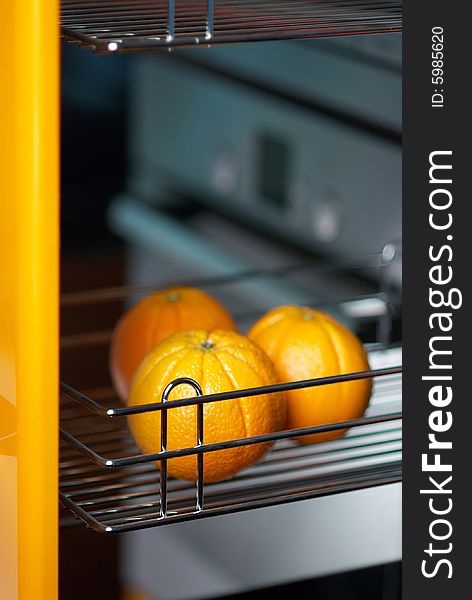 Tasty orange in kitchen in fridge