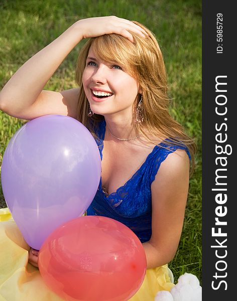 Happy girl with balloons in the park