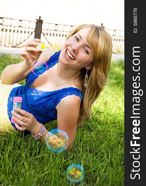 Playful girl with soap bubbles outdoor. Playful girl with soap bubbles outdoor