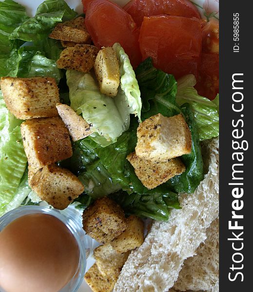 A Healthy Organic Breakfast consisting of an egg, lettuce, tomatoes, croûtons, bread.