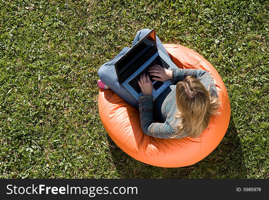 Beautiful woman working out sitting on orange puff