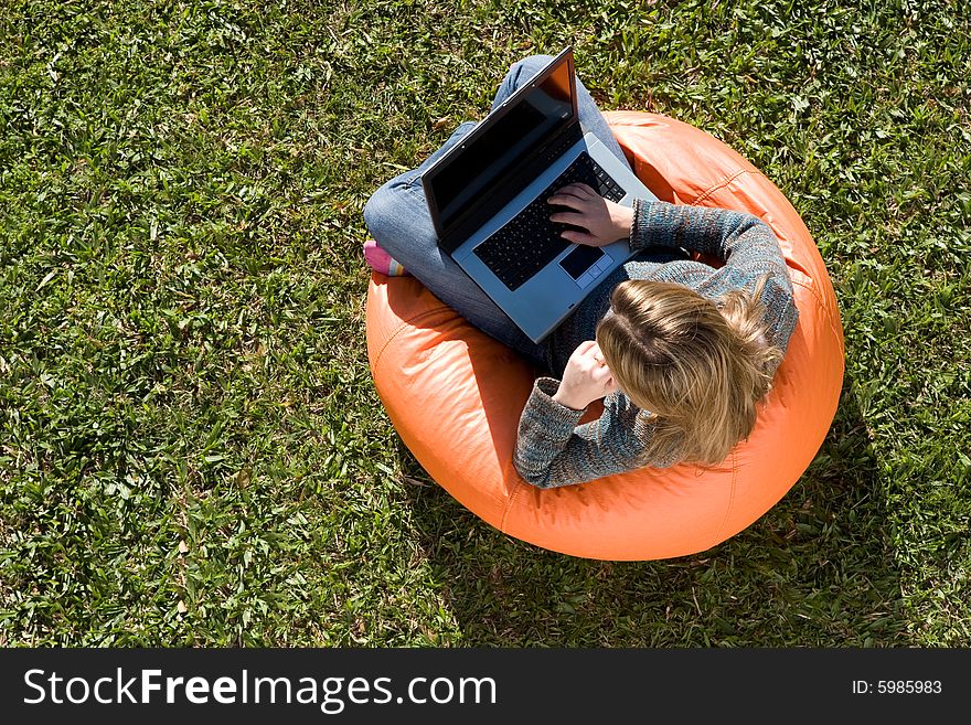 Beautiful woman working out sitting on orange puff