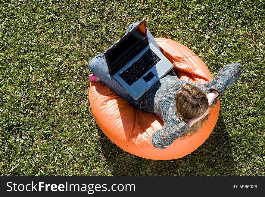 Beautiful woman working out sitting on orange puff