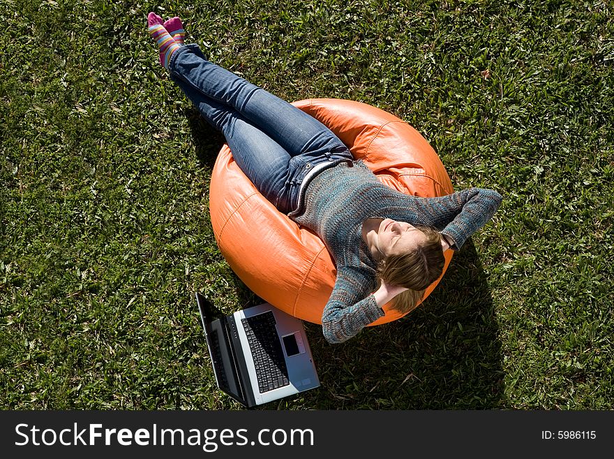 Beautiful woman working out sitting on orange puff