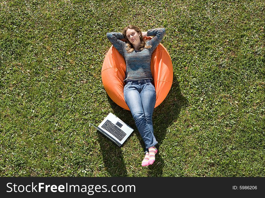 Beautiful woman working out sitting on orange puff