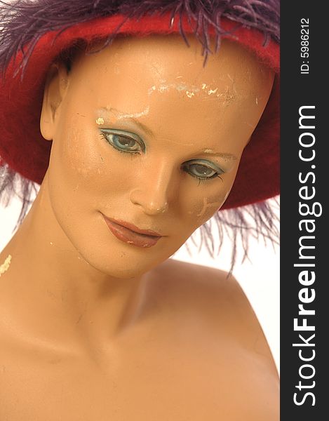 Old mannequin is wearing red hat. Old mannequin is wearing red hat