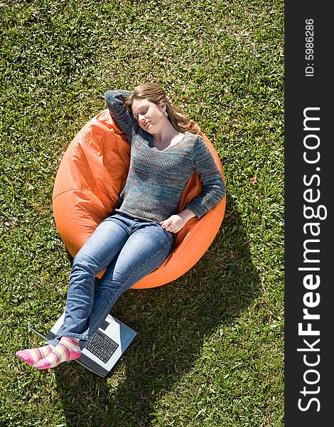 Beautiful woman working out sitting on orange puff