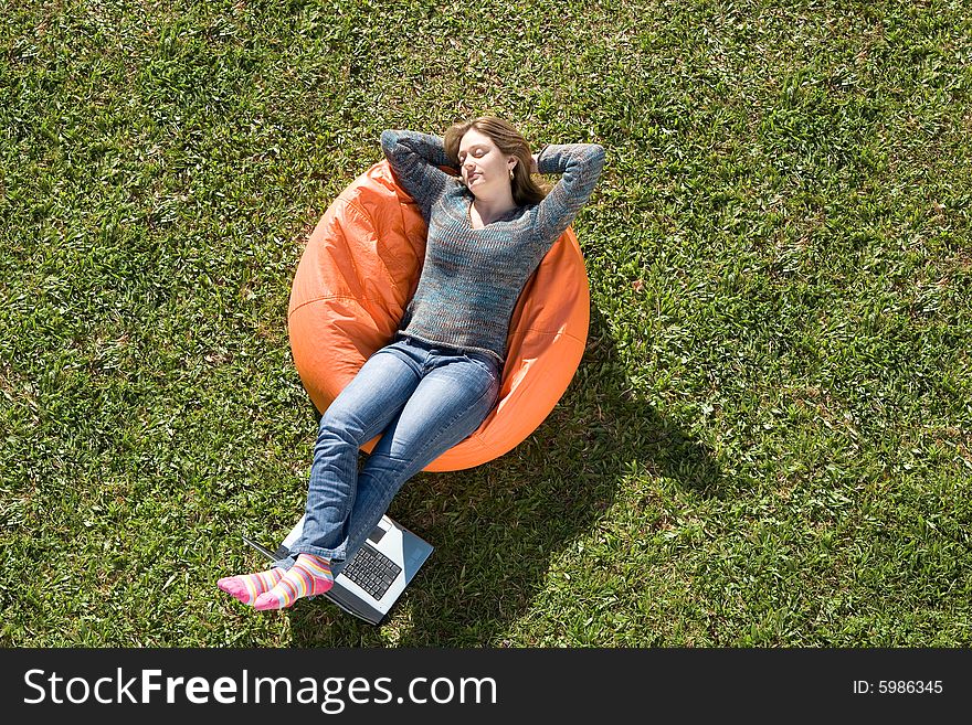 Beautiful woman working out sitting on orange puff