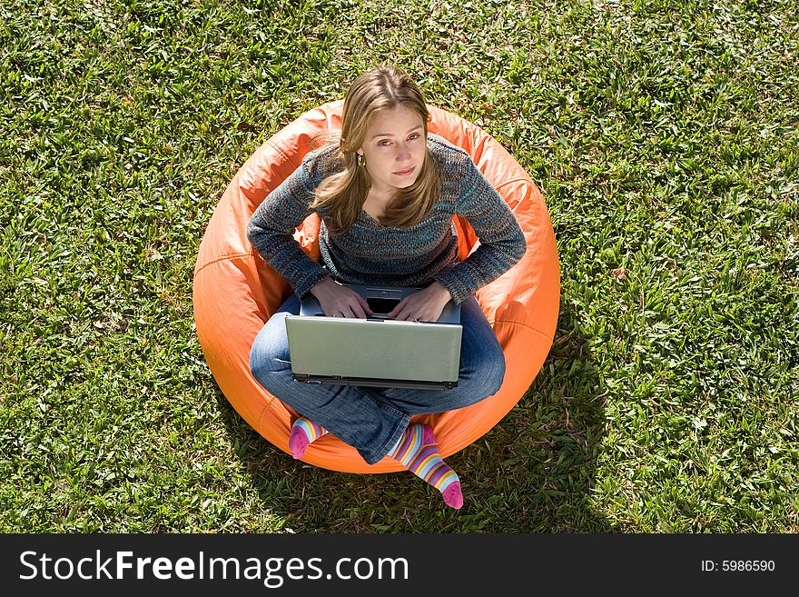 Beautiful woman working out sitting on orange puff