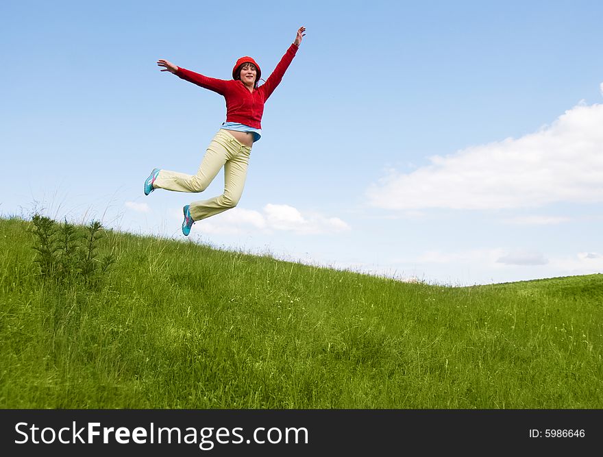 Happy free girl jumping on the hill. Happy free girl jumping on the hill