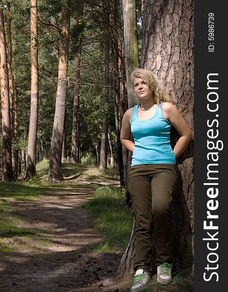 Young Beautiful Woman In A Summer Wood