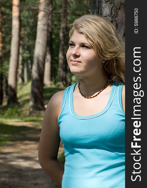 Young Beautiful Woman In A Summer Wood