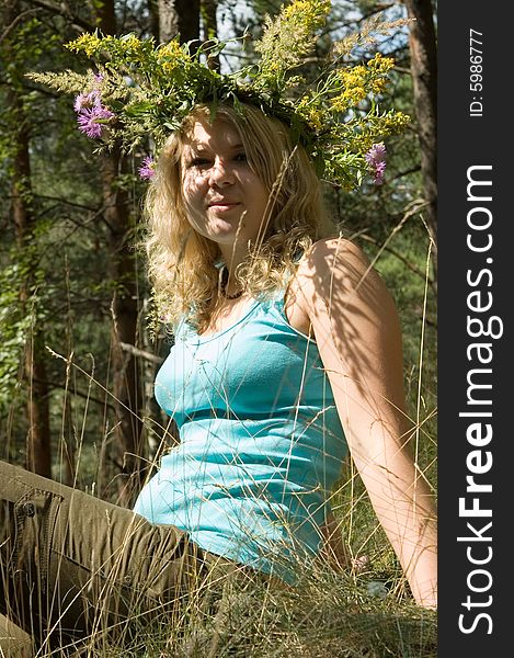 Young beautiful woman in a summer wood