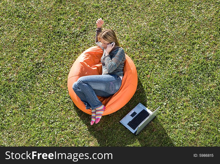 Beautiful woman working out sitting on orange puff