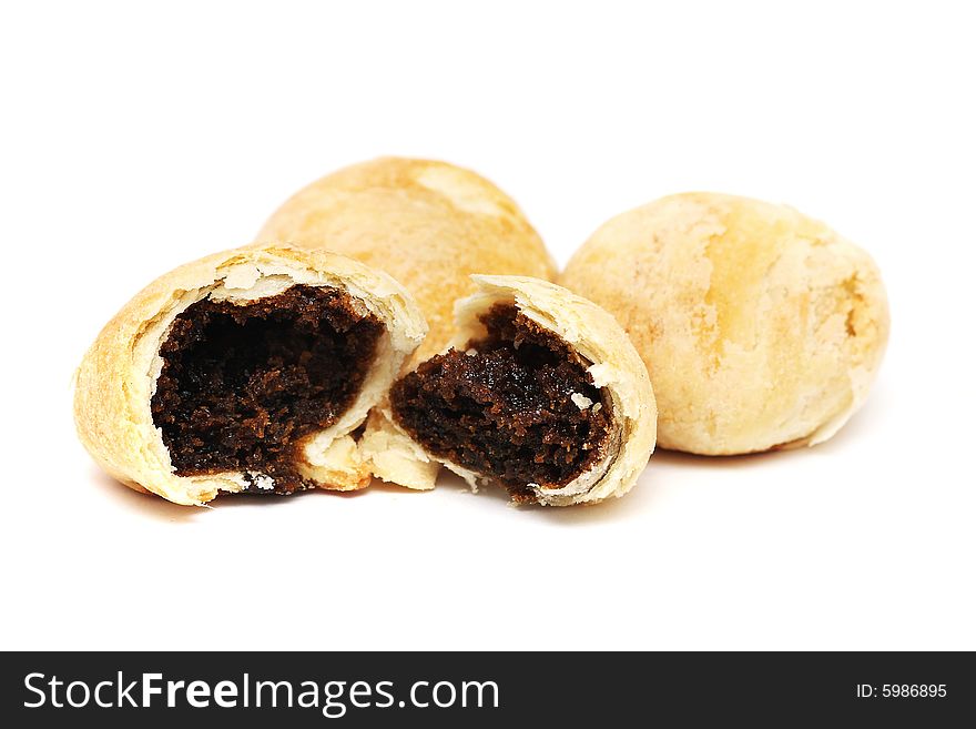 An teared red bean paste pastry isolated with others on white background. An teared red bean paste pastry isolated with others on white background.