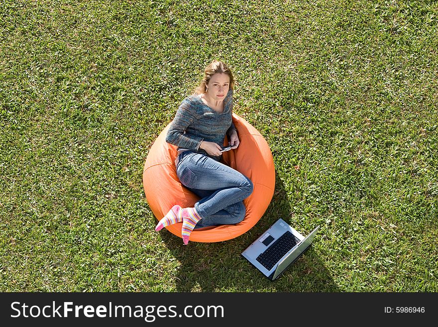 Beautiful woman working out sitting on orange puff