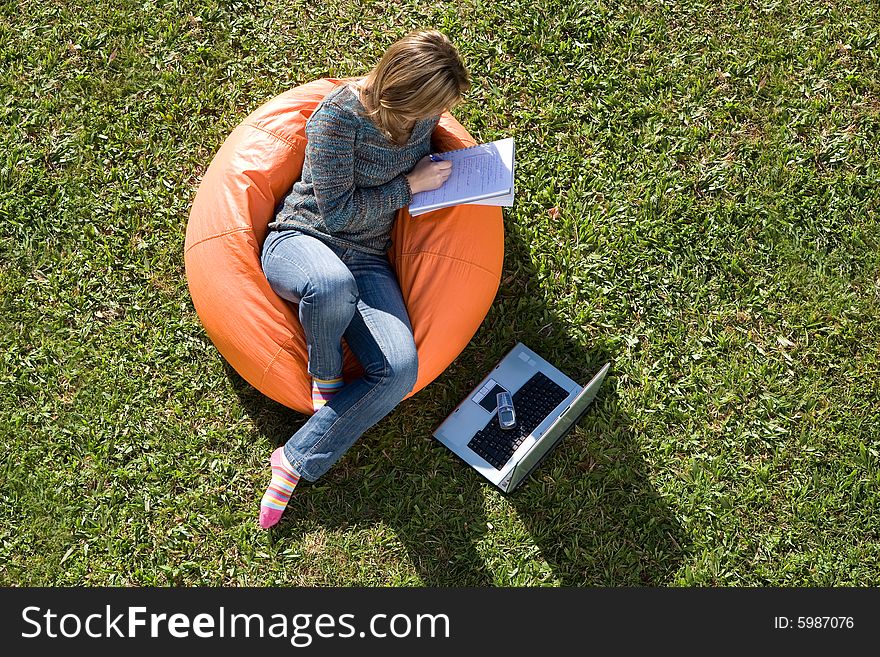 Beautiful woman working out sitting on orange puff