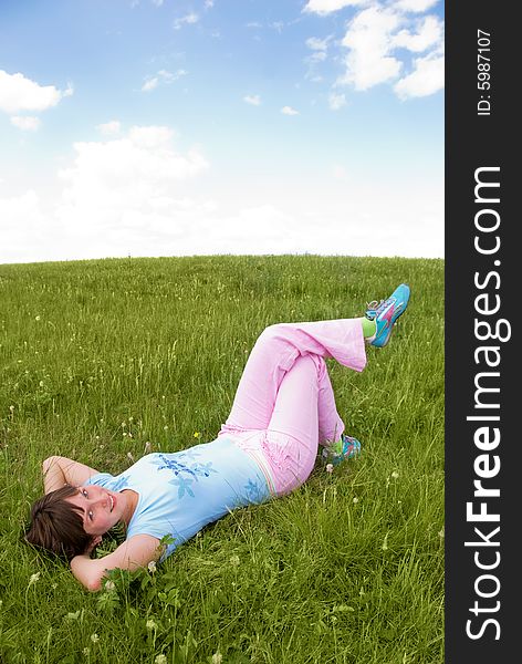 Pretty girl relaxing girl outdoor on the grass