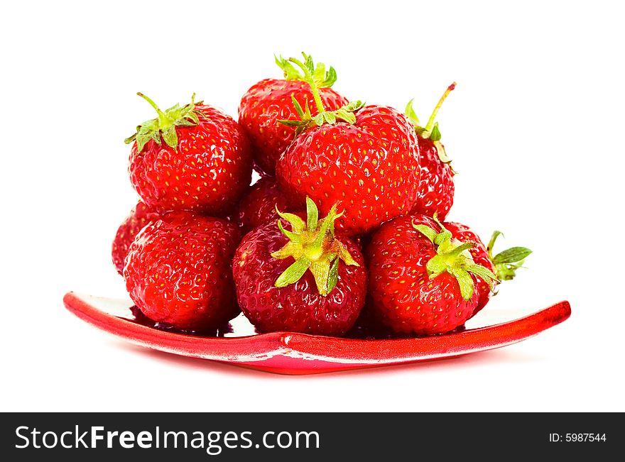 Strawberry on red plate over white background