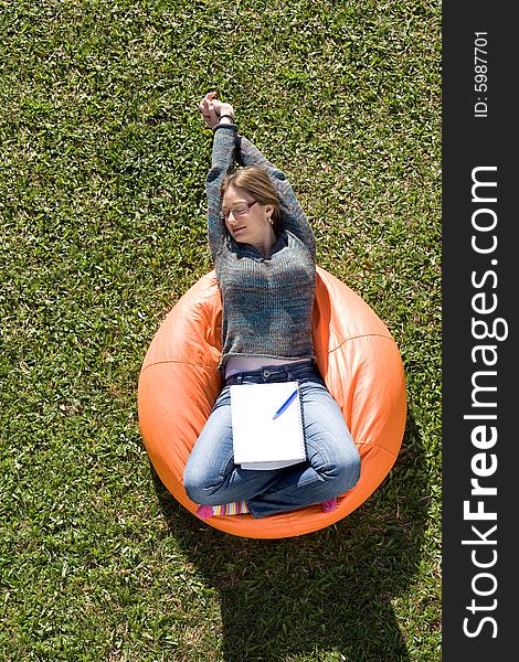 Beautiful woman working out sitting on orange puff