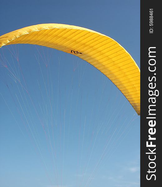 Yellow paraglide on the sky