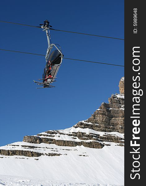 Ski lift chairs on bright winter day