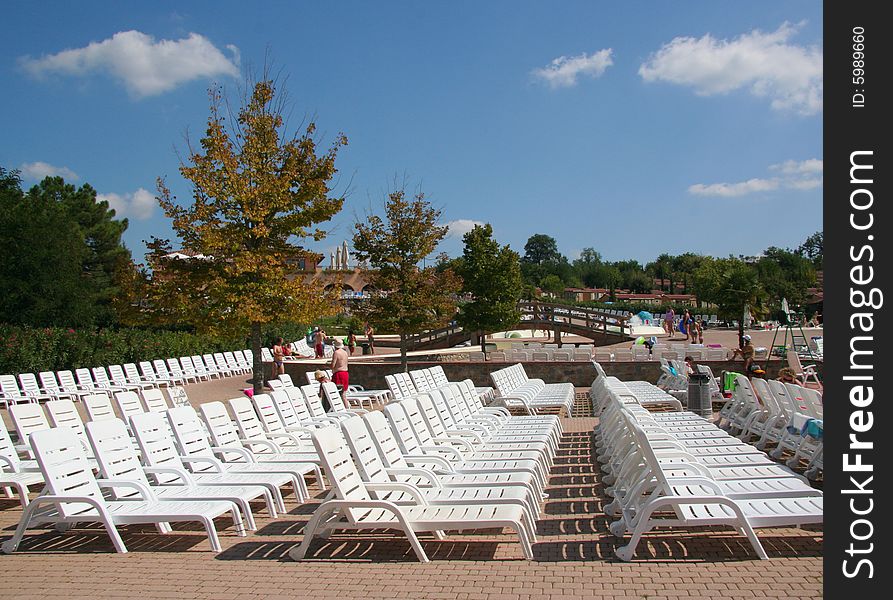 A row of empty pool chairs.