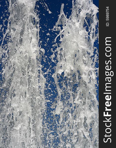 Fountain of water on a background of the blue sky. Fountain of water on a background of the blue sky