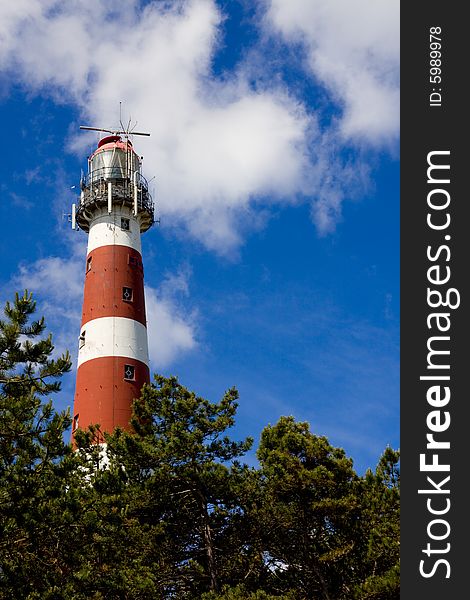 Ameland red and white lighthouse with blue sky. Ameland red and white lighthouse with blue sky