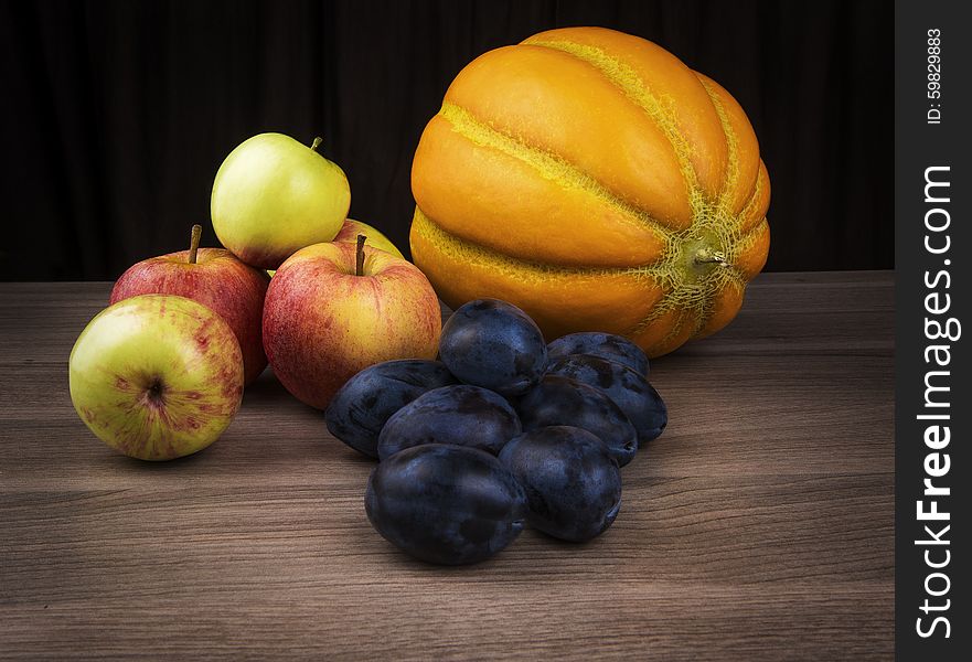 Melon,apples and plums of autumn still life