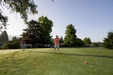 Couple Playing Golf On Course - Horizontal Royalty Free Stock Photos