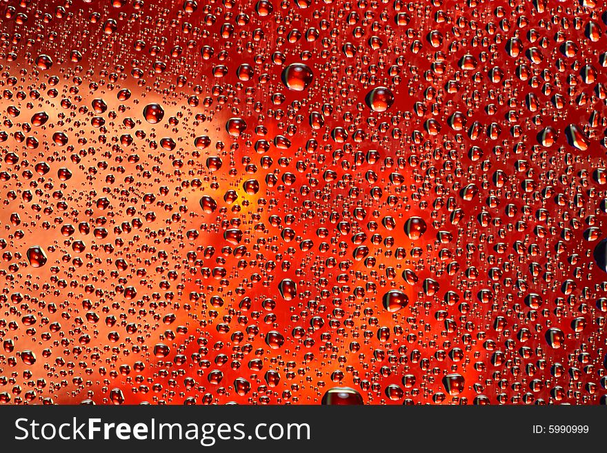 Drops of water on a red background. Drops of water on a red background.