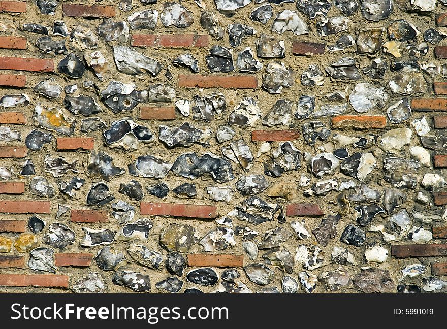 Close up of a Roman built English wall, the different courses of flint and brick are clearly visible. Close up of a Roman built English wall, the different courses of flint and brick are clearly visible.