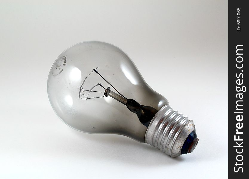 Close-up of a burnt light bulb on white background