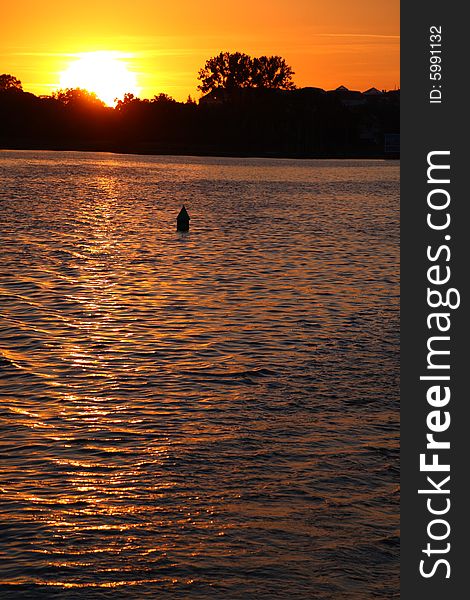 Buoy In Lake Over Sunset